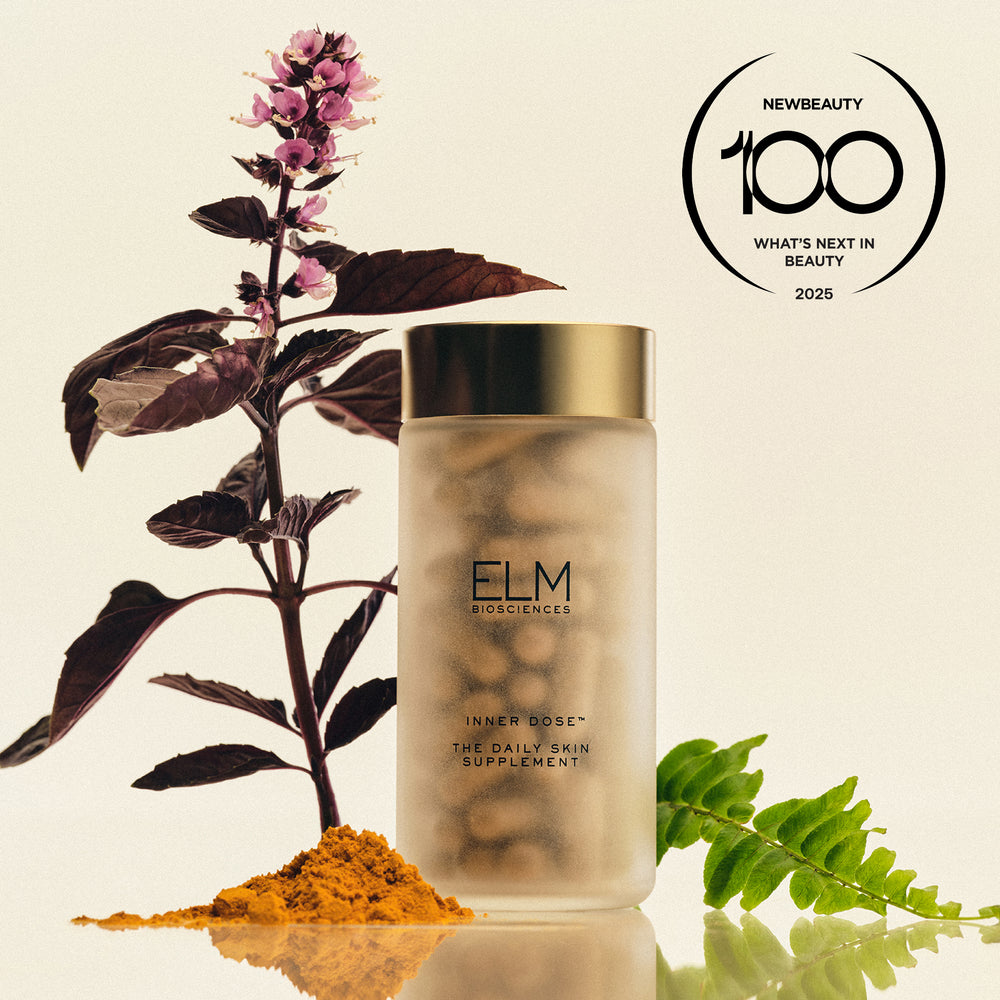 Front view of Inner Dose™ supplement bottle with frosted glass gold cap, botanicals, and NewBeauty award on light background